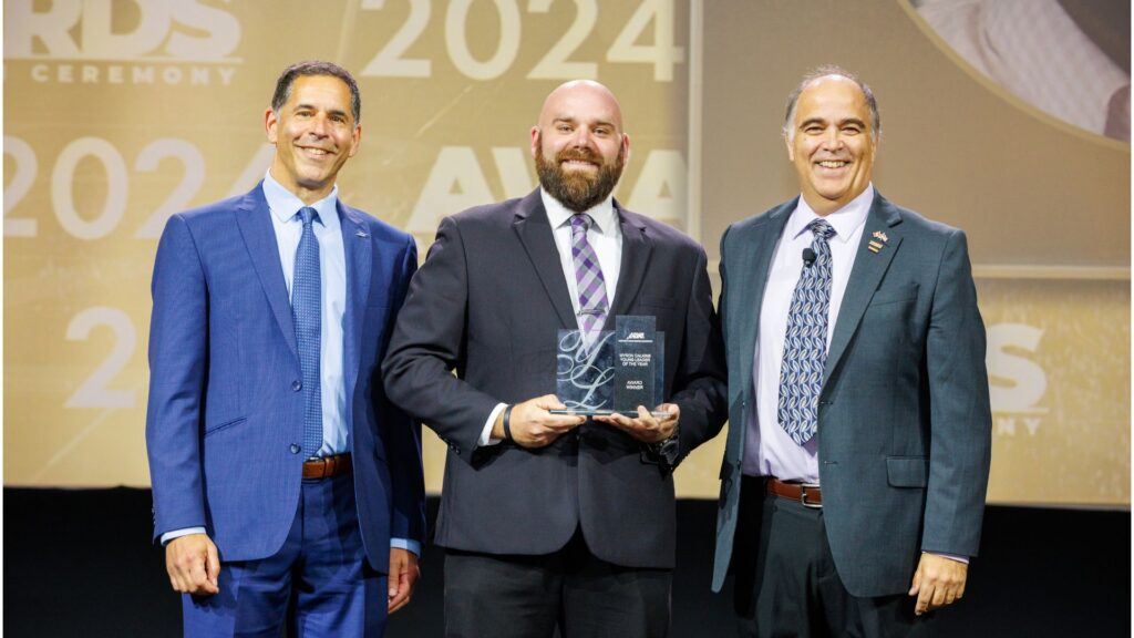Jon Loos holding the APWA National Young Leader of the Year award at the 2024 ceremony.
