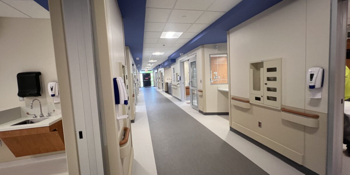 View down a hospital corridor from an ICU patient room doorway at Memorial Hospital Belleville