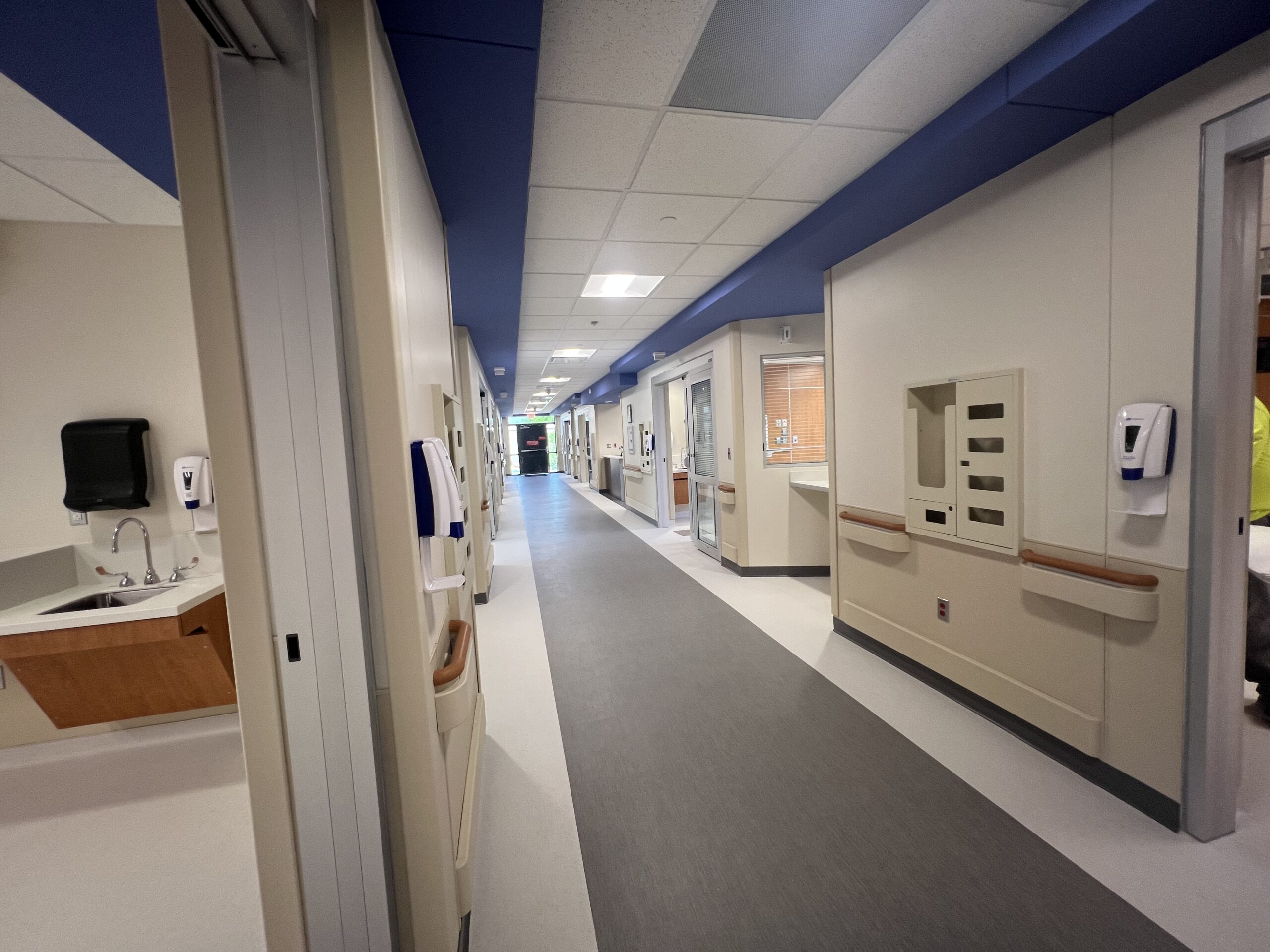 View down a hospital corridor from an ICU patient room doorway at Memorial Hospital Belleville