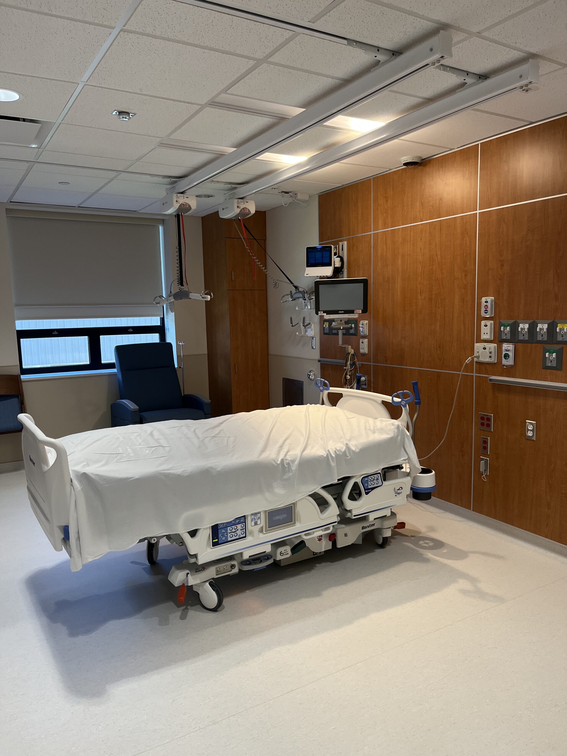 ICU patient room with hospital bed and wall-mounted medical equipment at Memorial Hospital Belleville