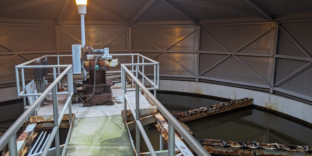 Metal catwalk over treatment basins inside the City of Portageville water treatment facility That's descriptive of what someone actually sees and doesn't try to force the article's funding message into the accessibility field.